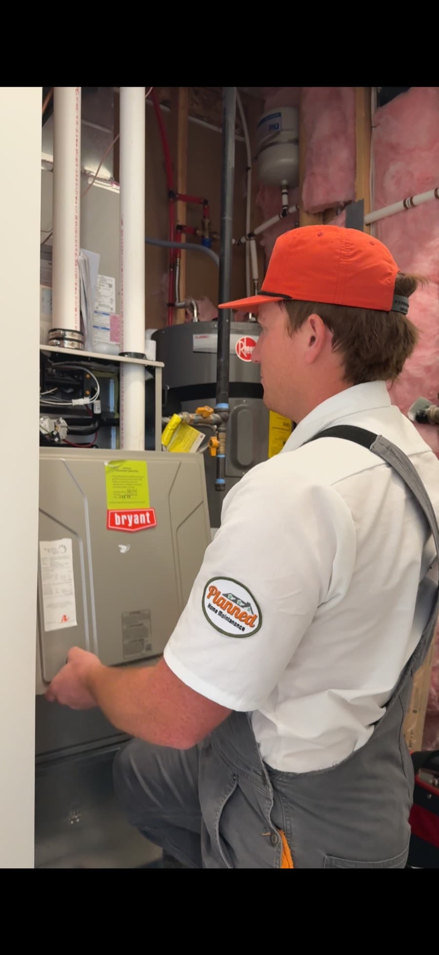 Planned technician removing a furnace cover during a maintenance visit